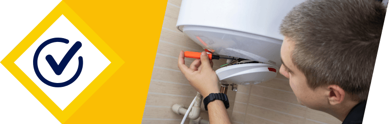 Miami handyman repairing a home water heater with a screwdriver